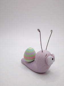 Little pastel Easter snail with Easter egg on his back