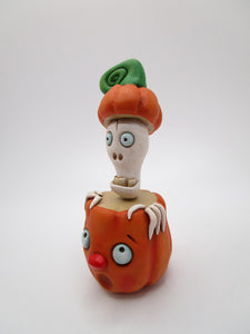 Halloween folk art Skelly inside a pumpkin