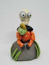 Halloween folk art Skelly Skeleton sitting on a rock