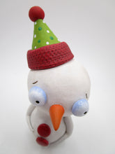 Christmas snowman with festive party hat in holiday colors