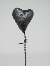 Valentines or love character "WHY" with barbed wire heart balloon