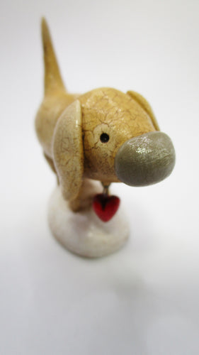 Folk art style yellow dog with heart charm